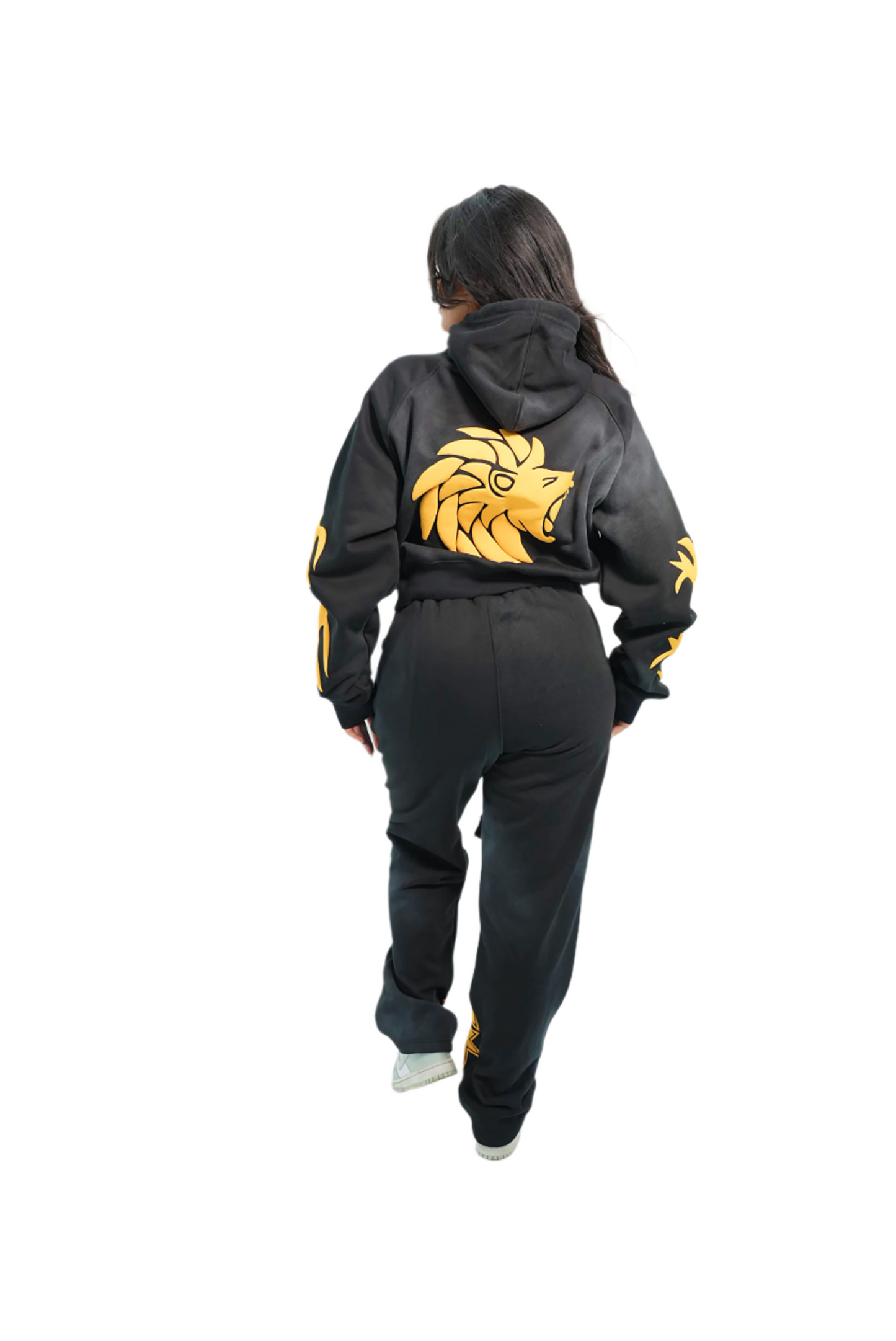 Person wearing a black hoodie with a gold lion emblem on the back, standing against a white background.