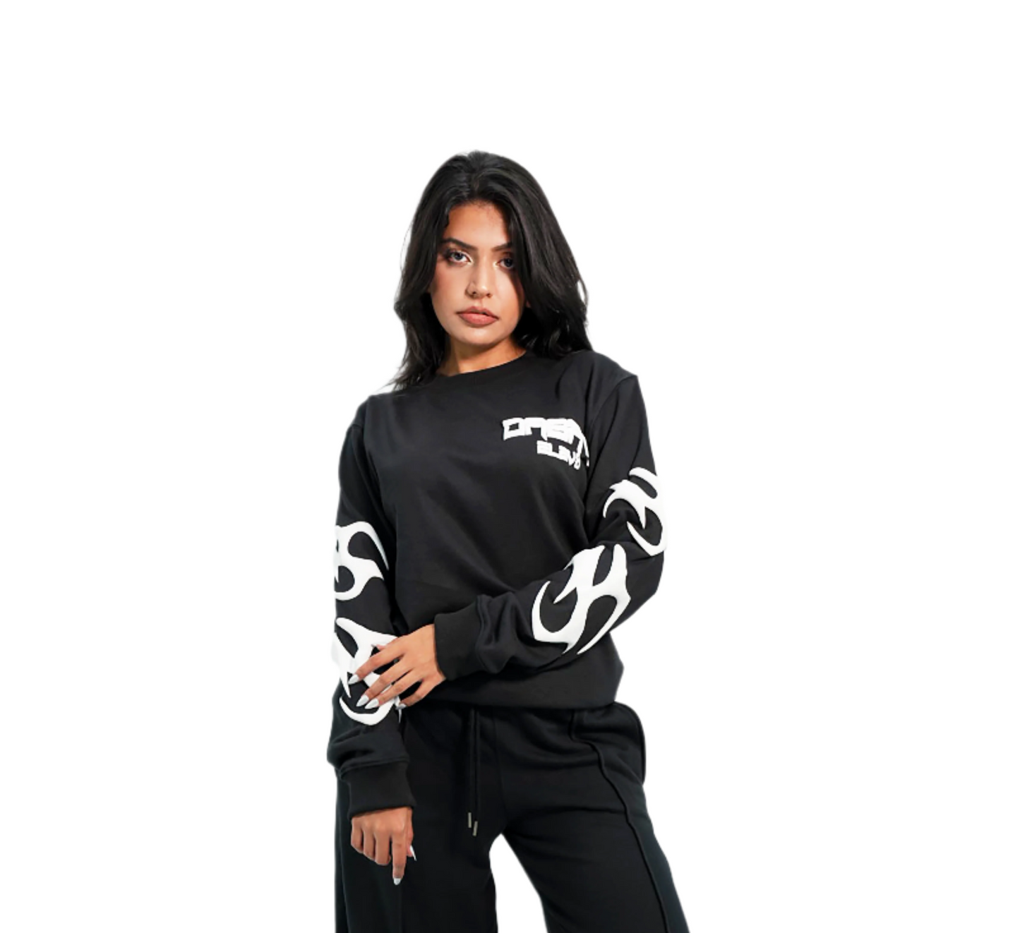 Person wearing a black long-sleeve shirt with white graphics and black pants on a white background