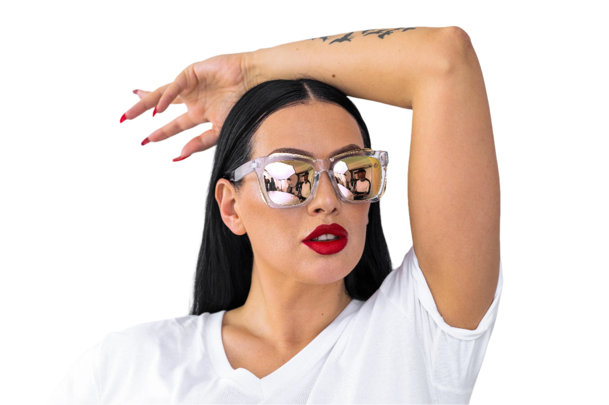 Woman wearing large reflective sunglasses and a white top against a light background