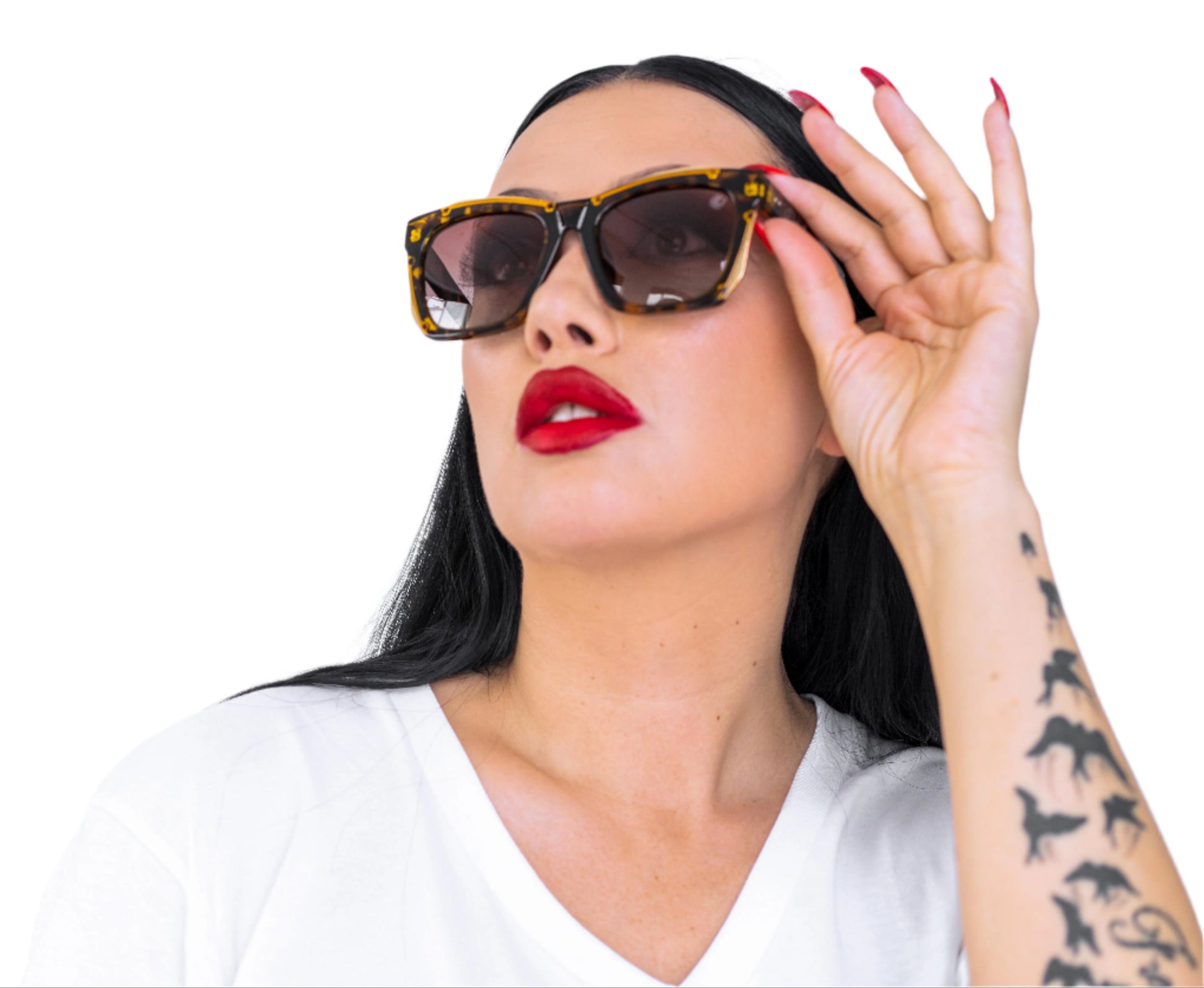 Woman wearing sunglasses and a white top with a tattooed arm on a white background