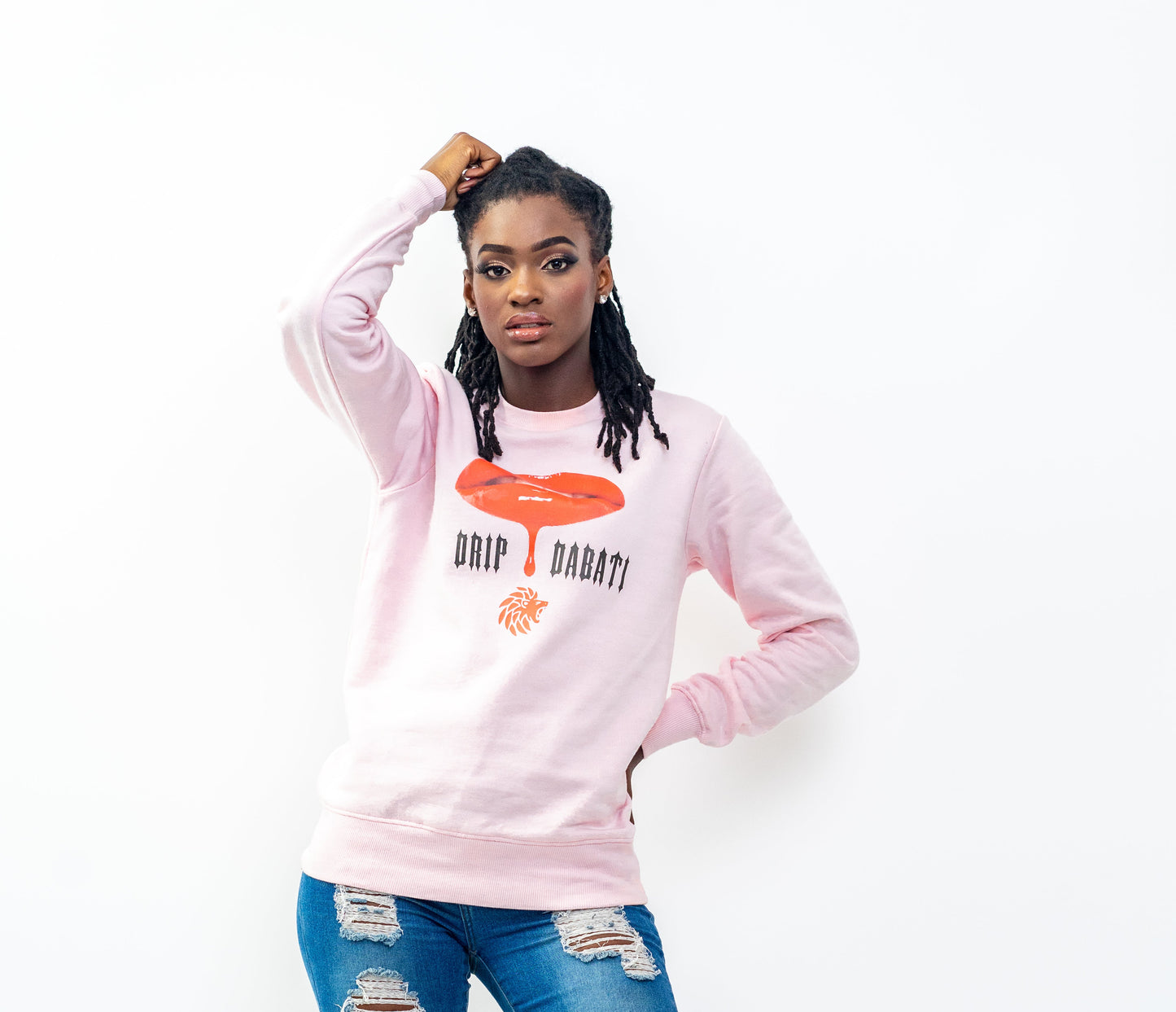 Person wearing a pink sweatshirt with text and graphics on a white background