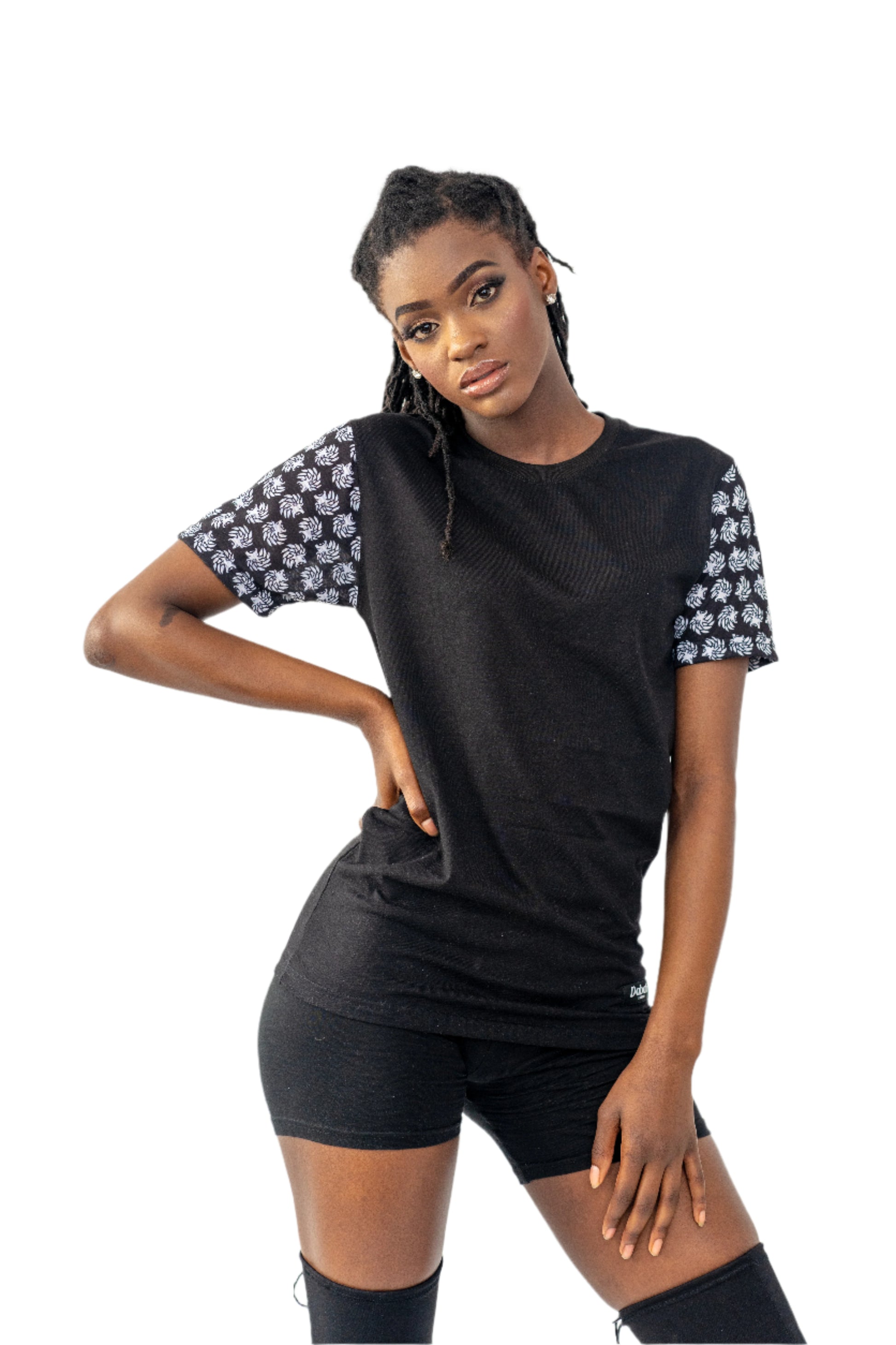 Woman wearing a black outfit with floral sleeves on a white background