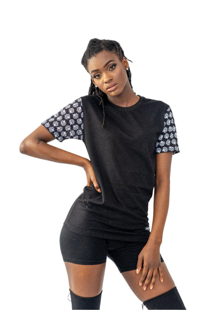 Woman wearing a black outfit with floral sleeves on a white background