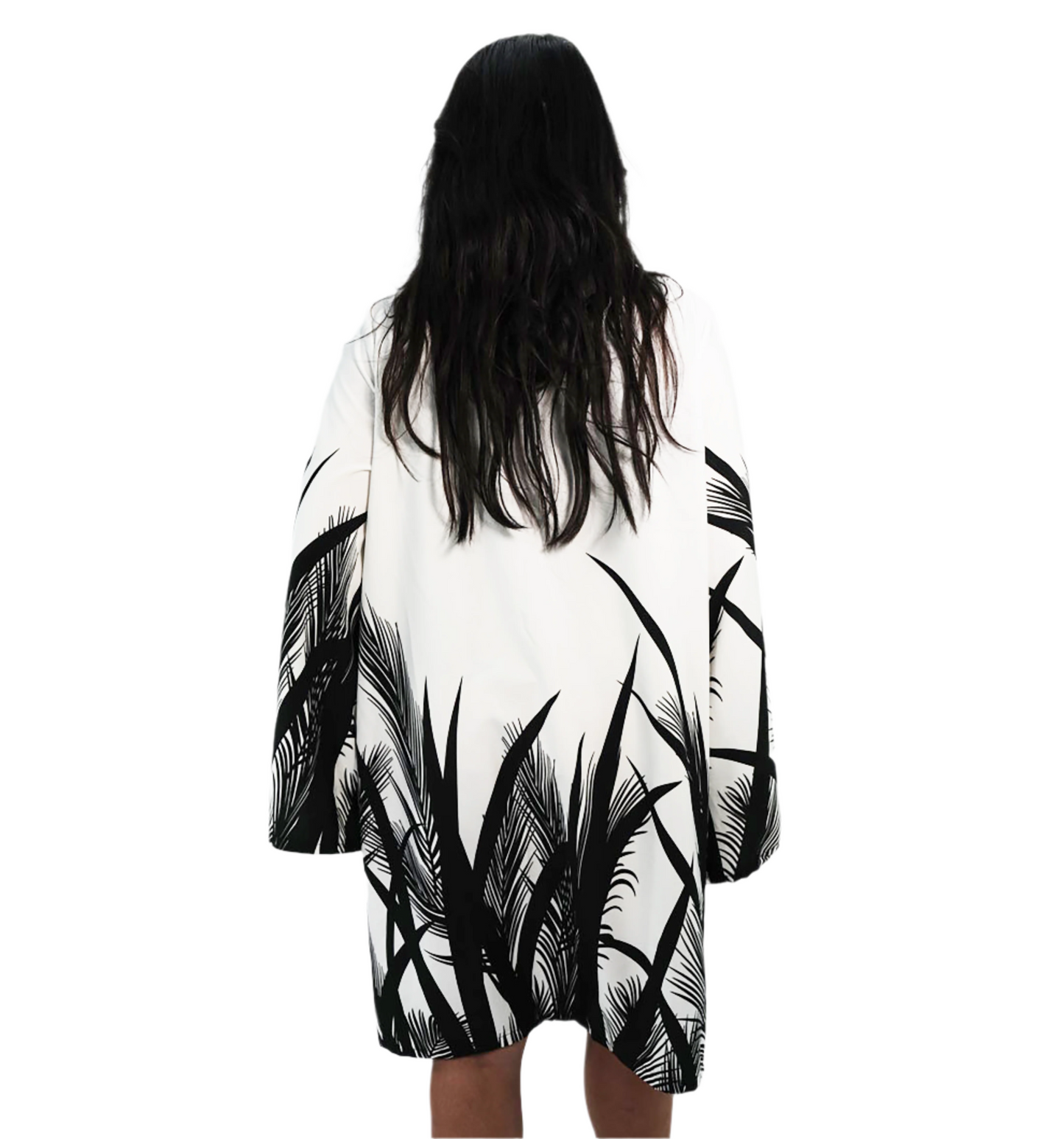 Person wearing a black and white patterned kimono-style garment on a plain background
