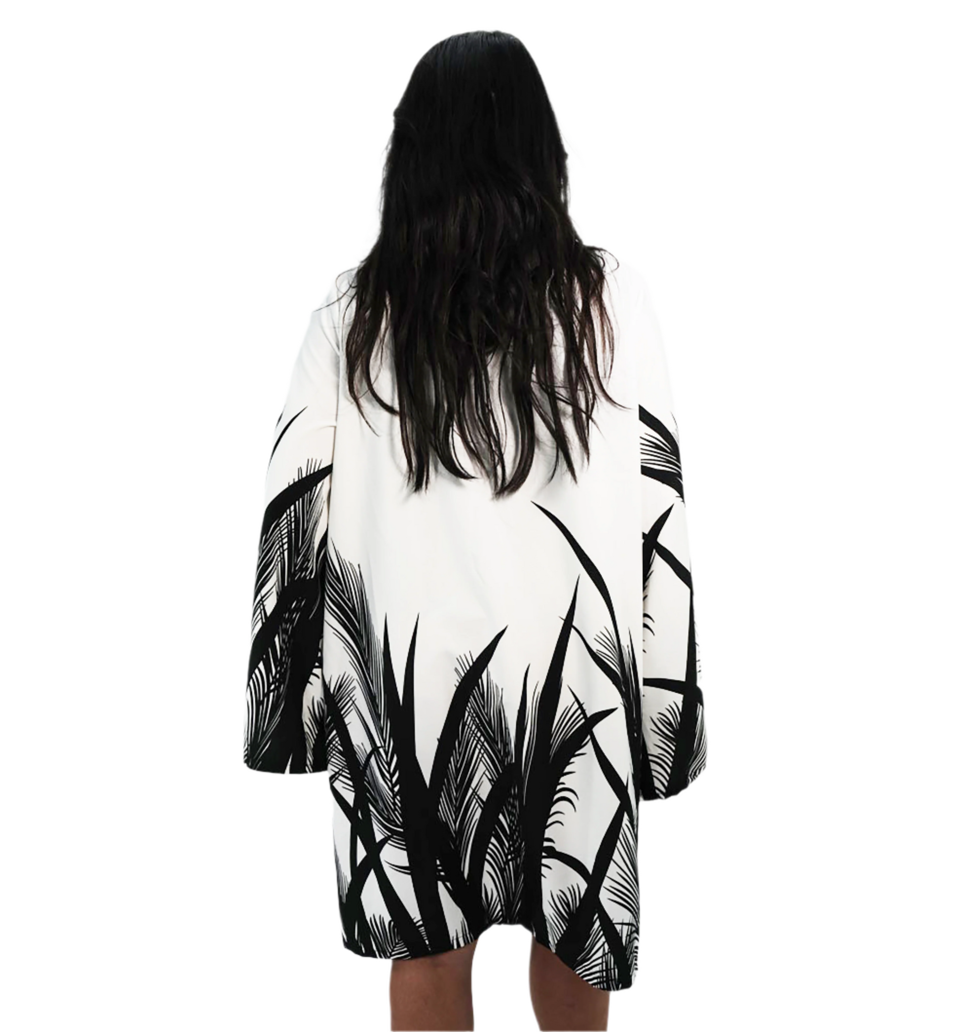 Person wearing a black and white patterned kimono-style garment on a plain background