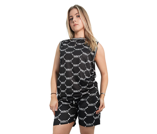 Woman wearing a black and white patterned sleeveless top and shorts set with knee-high black boots on a white background.