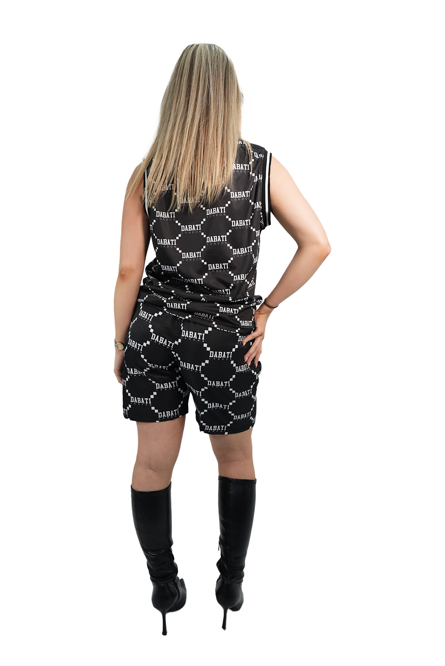 Person wearing a black and white patterned romper on a white background