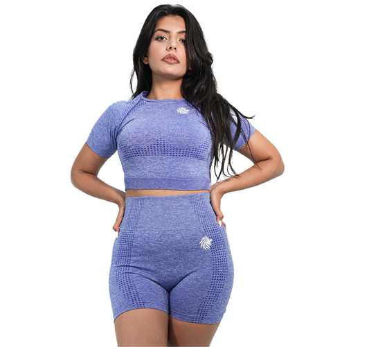 Woman wearing a blue athletic outfit on a white background