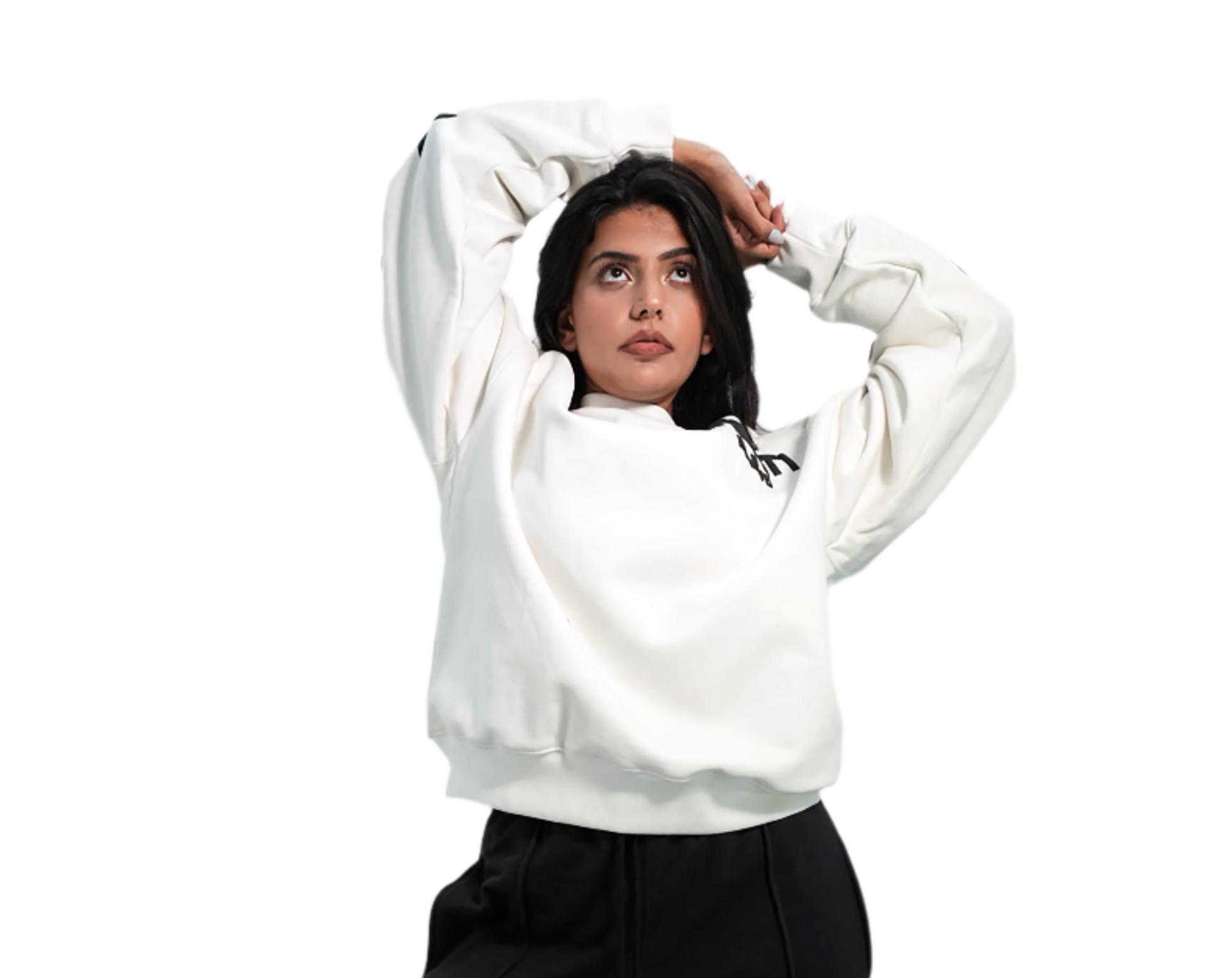 Person wearing a white sweatshirt and black pants against a plain background