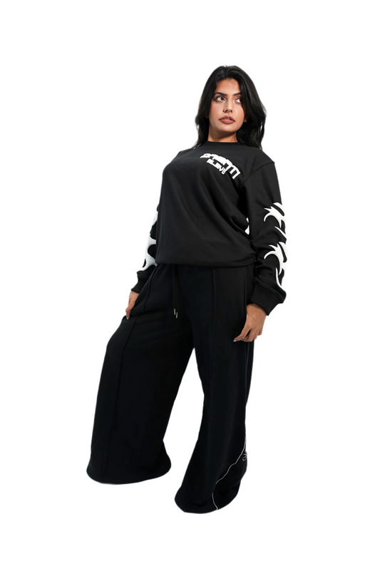 Person wearing a black outfit with white text and designs on a white background