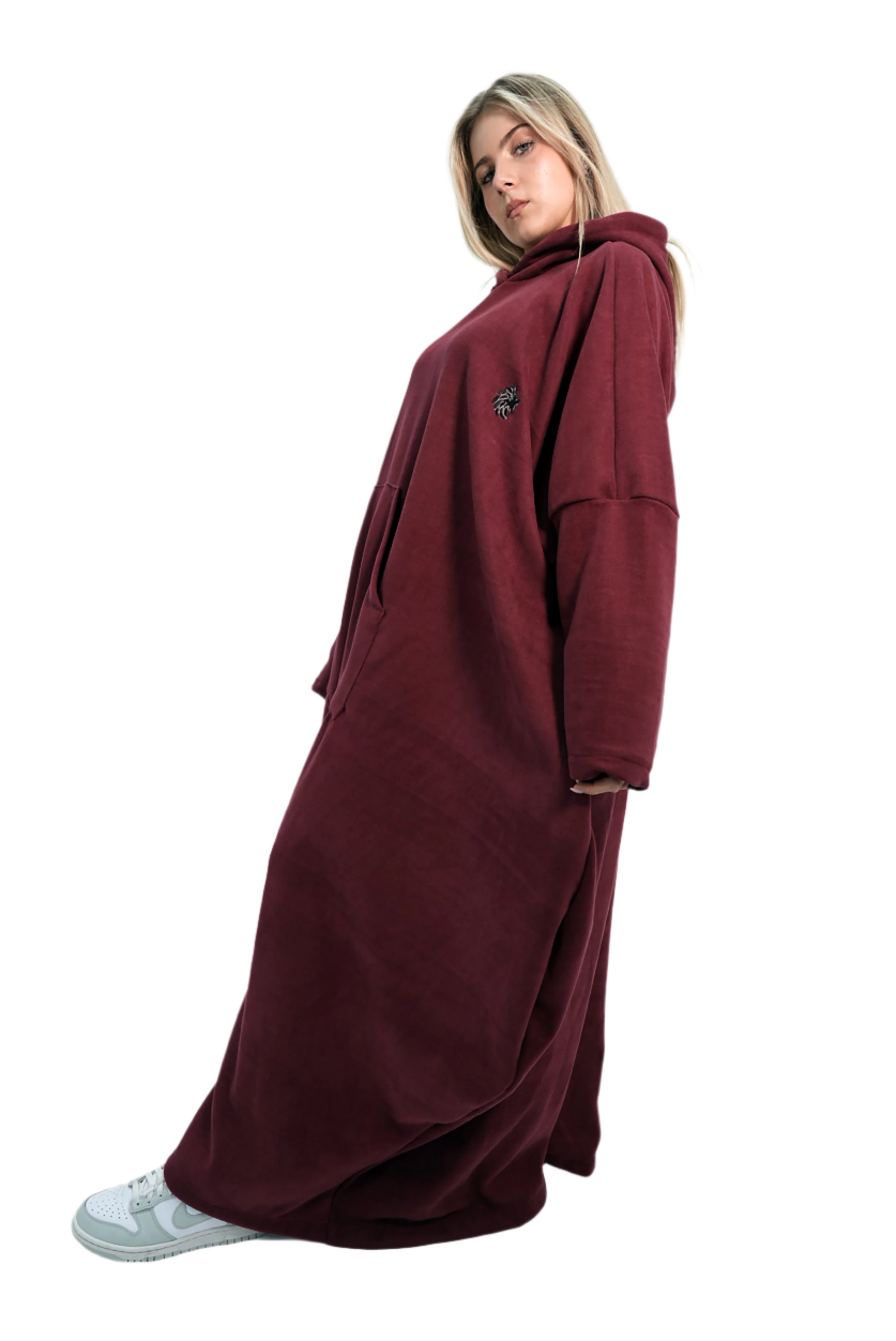 Person wearing a long burgundy hoodie against a white background