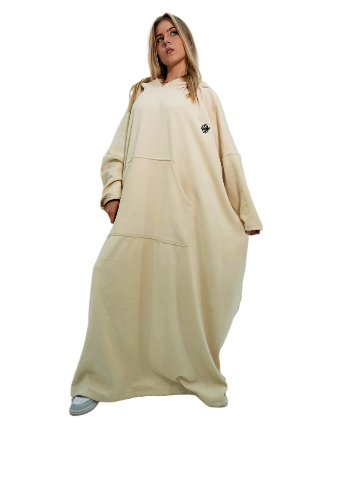 Woman wearing a beige outfit with a long dress and jacket on a white background