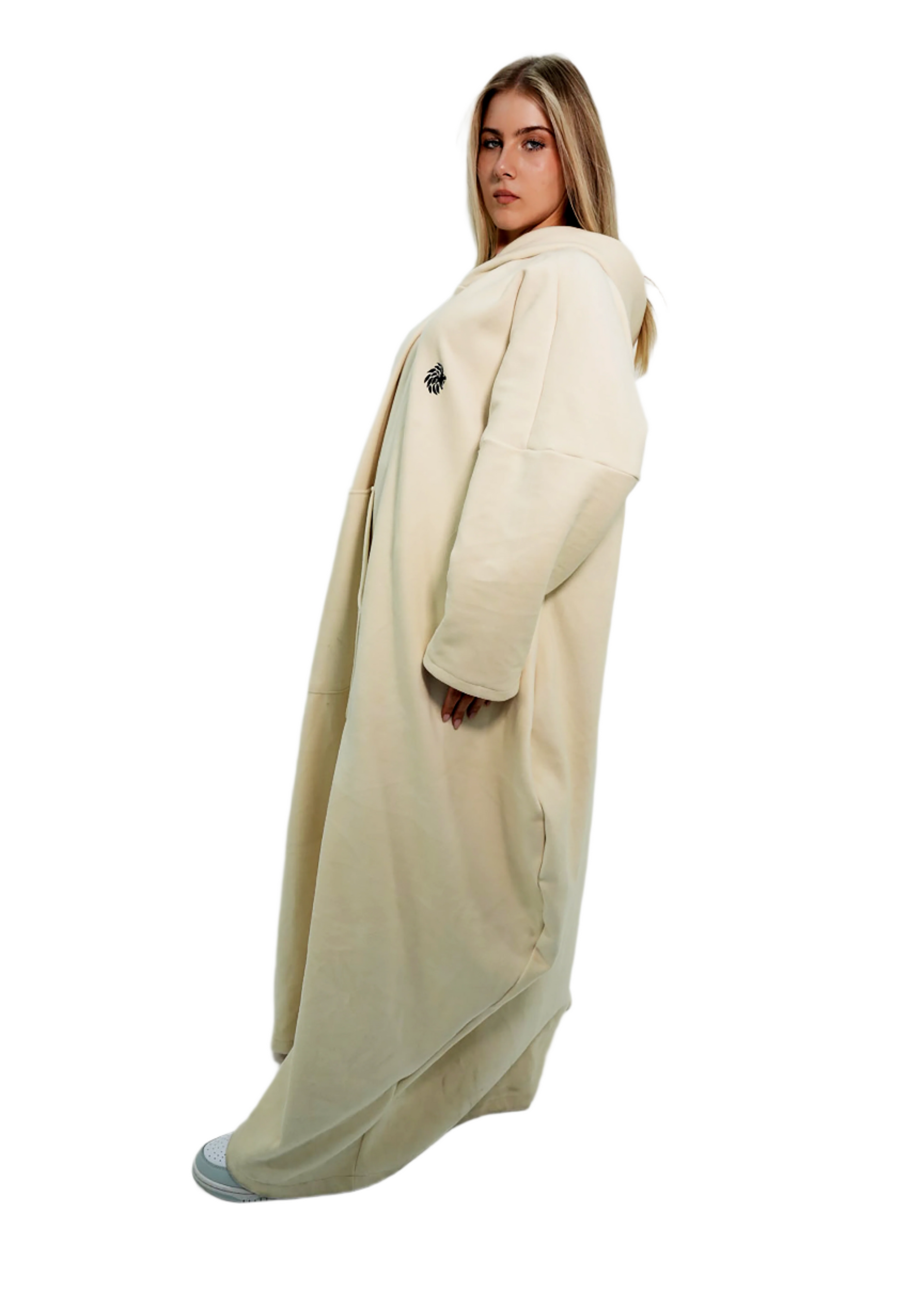 Woman wearing a long beige coat on a white background