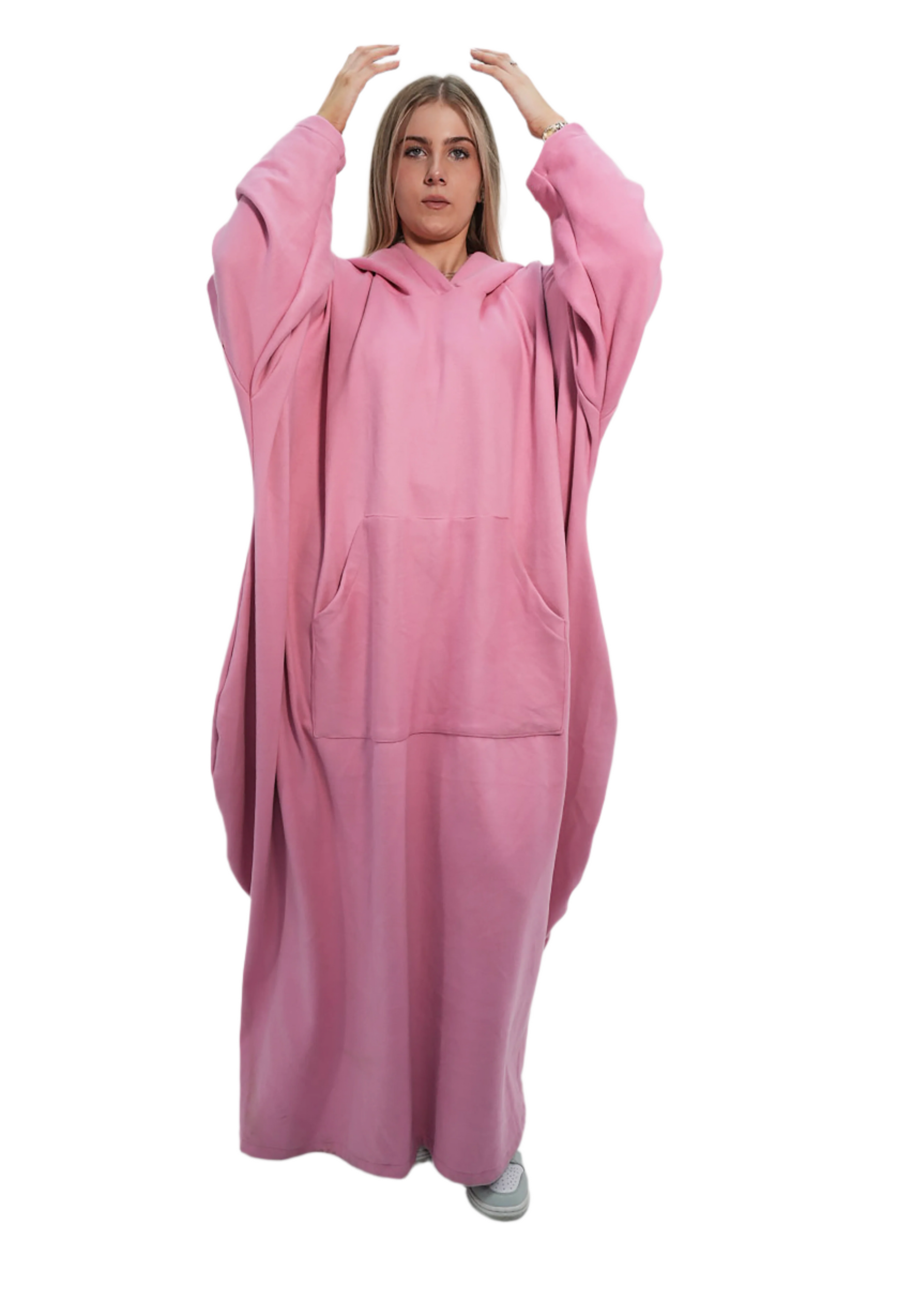 Person wearing a pink onesie against a plain background