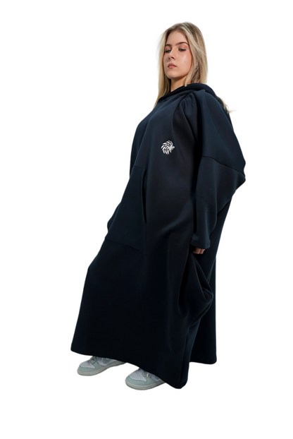 Person wearing a black cape with a logo on a white background